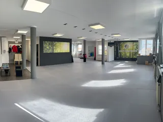 Trainingshalle der Taekwon-Do Schule Könnecke in Salzburg mit Kampfsportmatten, Spiegelwand und Boxsack