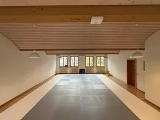 Meditationsraum Sankt Zeno in Bad Reichenhall, Trainingsraum der Taekwon-Do-Gruppe mit Matten und Holzdecke